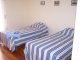 Twin bedroom , large and airy with patio doors onto patio area , spectacular sea views . 